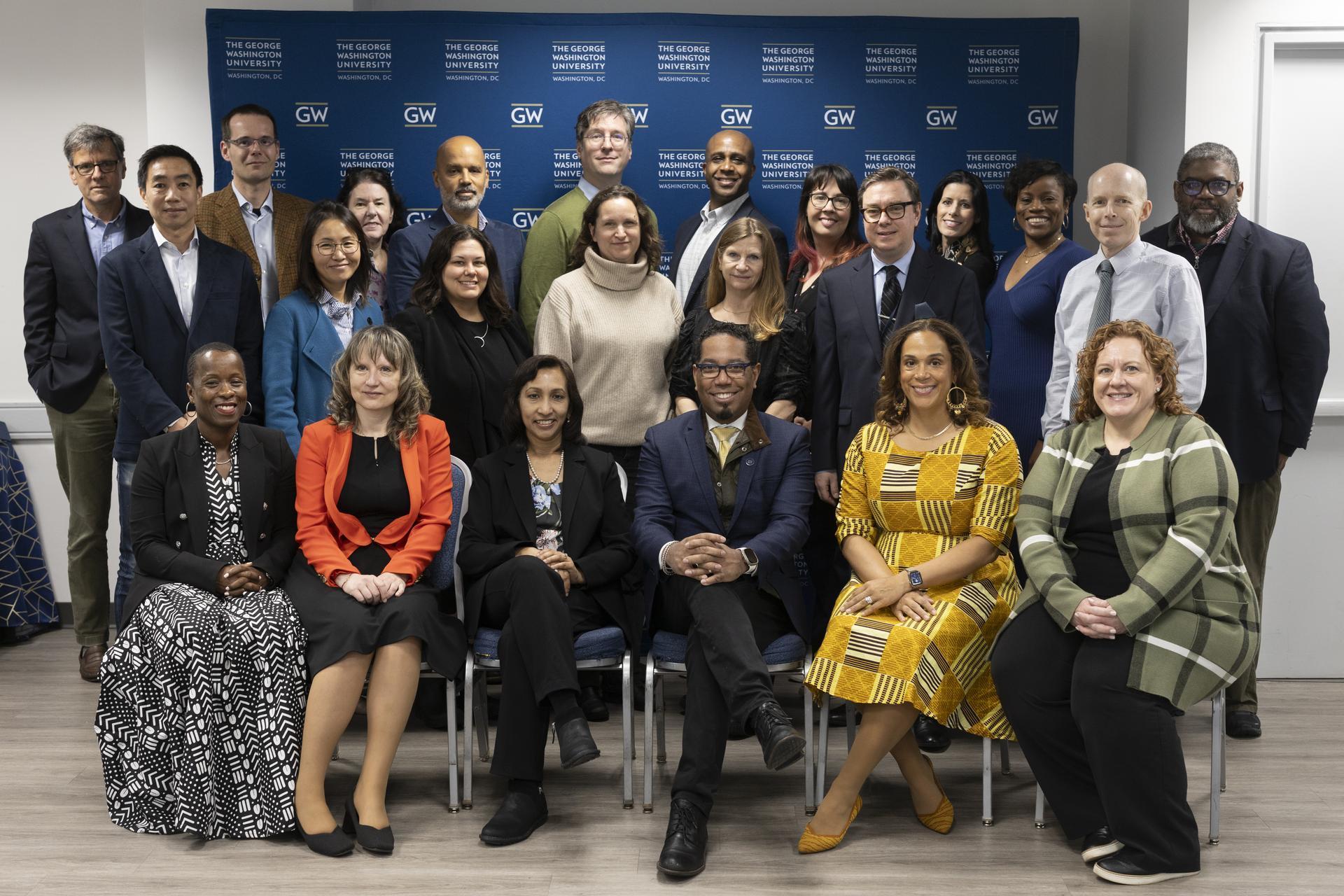Members of the fifth GWALA cohort joined Provost Bracey for a group graduation photo. Faculty and staff from GW pose with Provost Christopher Bracey in front of a blue banner