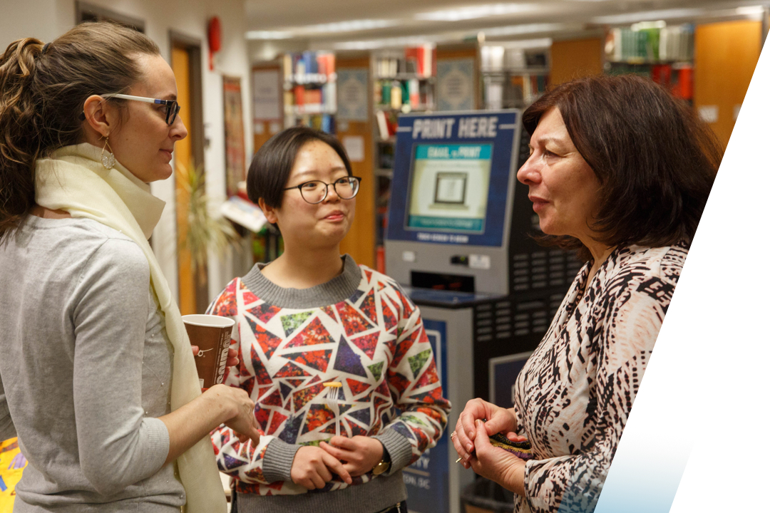 Female students talking to professor