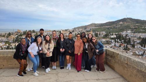 Group of students from GW with a professor and support staff